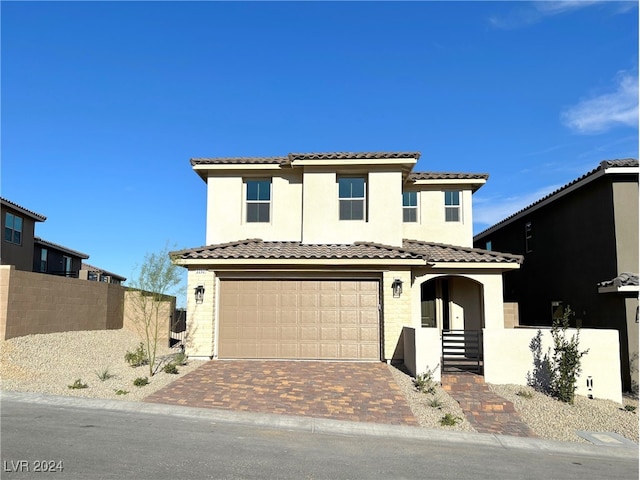 mediterranean / spanish house featuring a garage