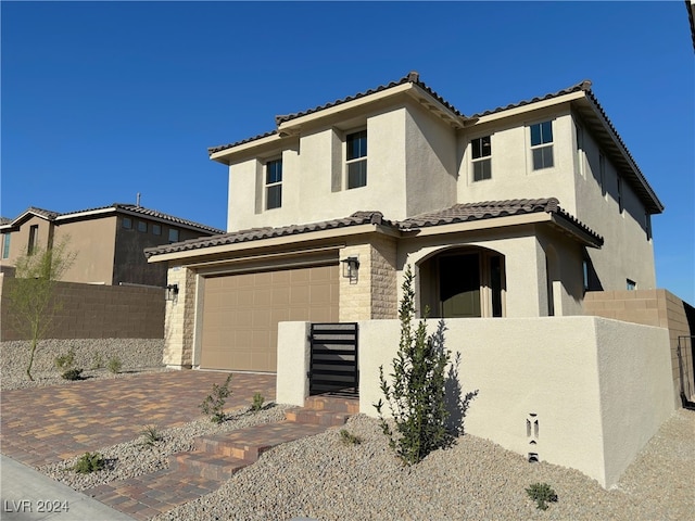 mediterranean / spanish-style home featuring a garage