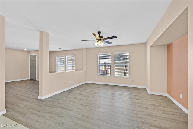 unfurnished living room with ceiling fan and light wood-type flooring