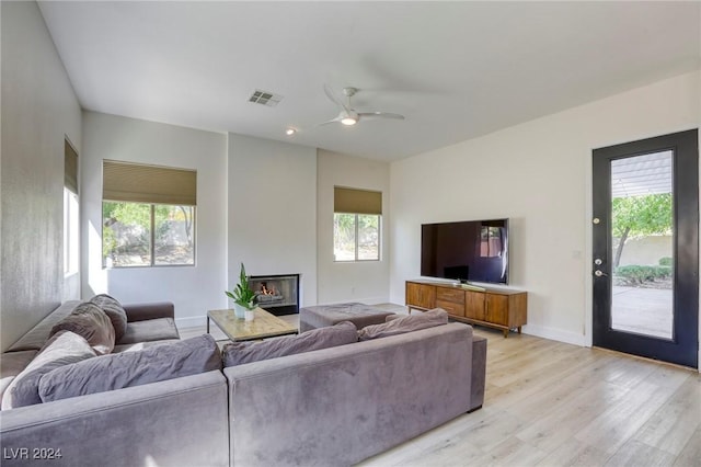 living room featuring ceiling fan, a healthy amount of sunlight, and light hardwood / wood-style floors