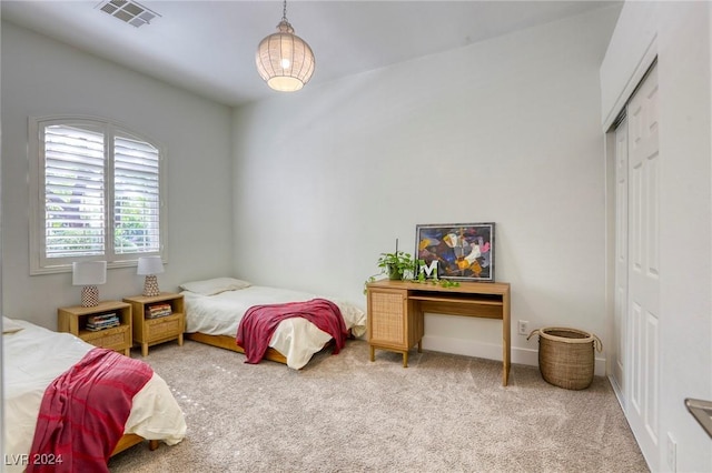 bedroom with carpet and a closet