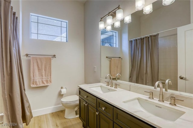 bathroom featuring toilet, vanity, a shower with shower curtain, and hardwood / wood-style flooring