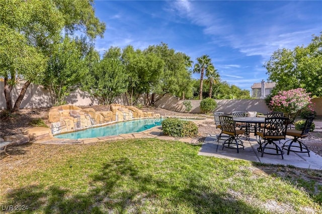 view of yard with a fenced in pool and a patio