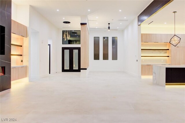 unfurnished living room with a ceiling fan and recessed lighting