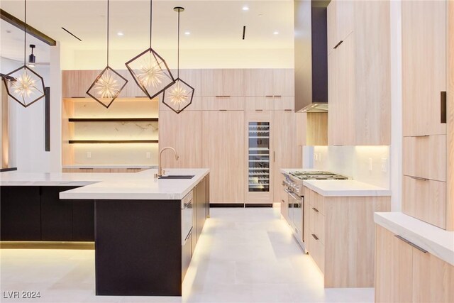 kitchen featuring decorative light fixtures, light countertops, a sink, and stainless steel stove