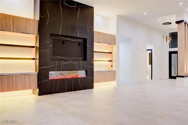 unfurnished living room with a high ceiling and recessed lighting