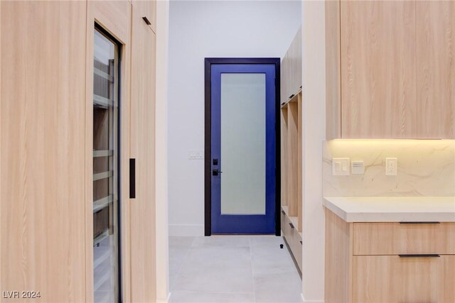 bathroom with baseboards and tile patterned floors