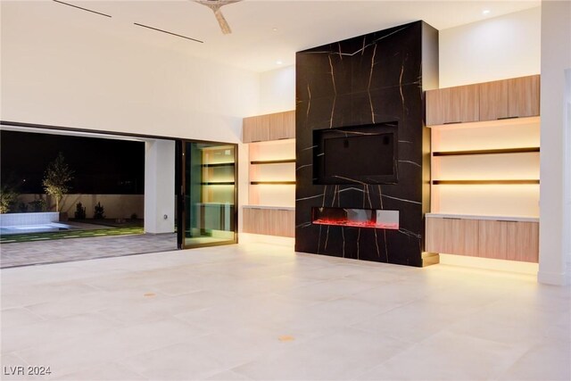 unfurnished living room with a high ceiling