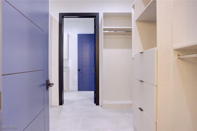 spacious closet featuring light tile patterned floors