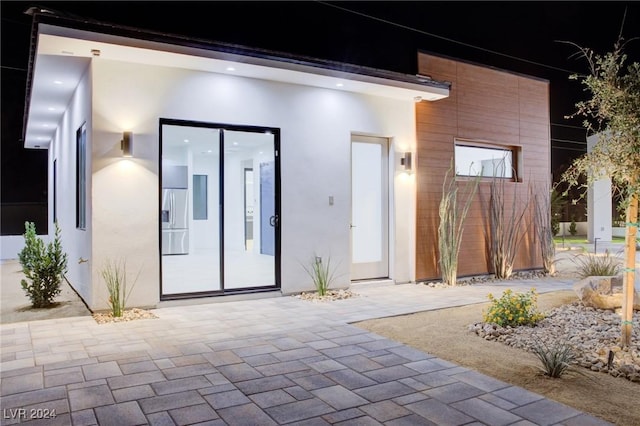 property entrance with stucco siding