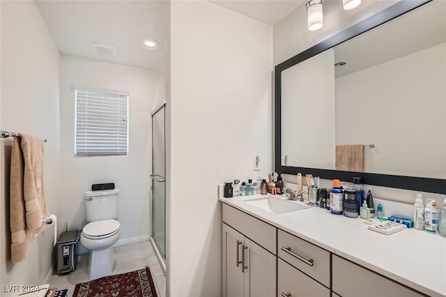 bathroom featuring walk in shower, vanity, toilet, and tile patterned floors