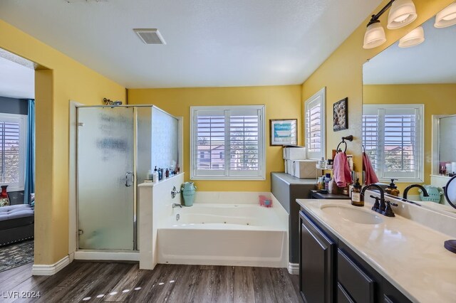 bathroom with vanity, hardwood / wood-style floors, and separate shower and tub