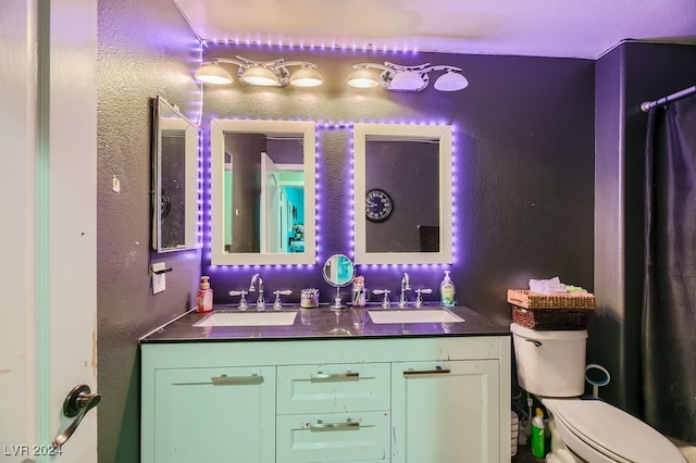 bathroom with toilet and vanity