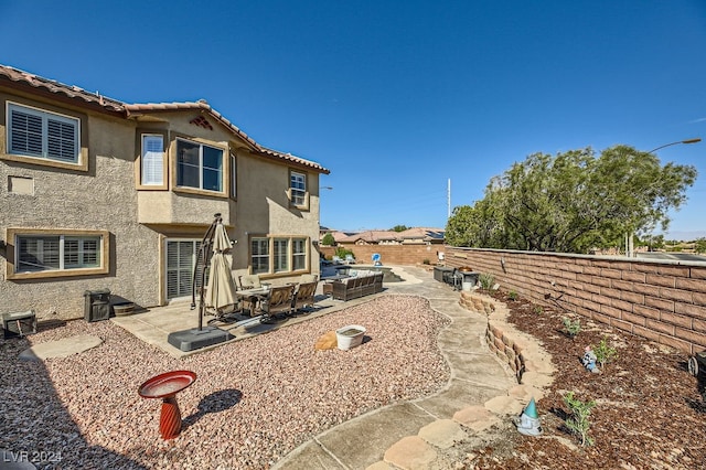 back of house with a patio and an outdoor hangout area