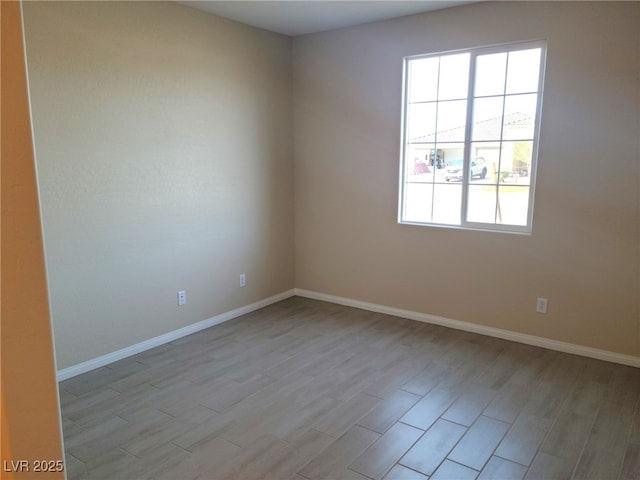 unfurnished room with light wood-type flooring