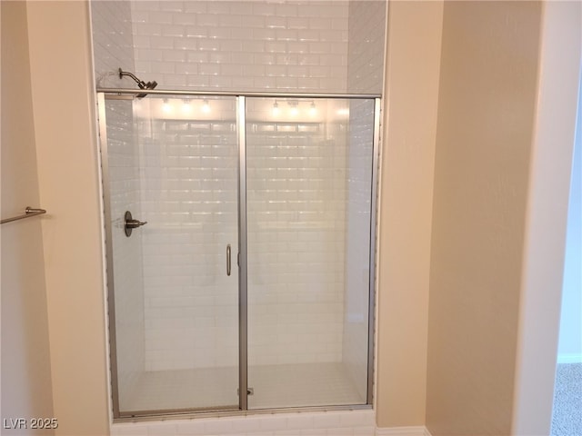 bathroom featuring a shower with shower door