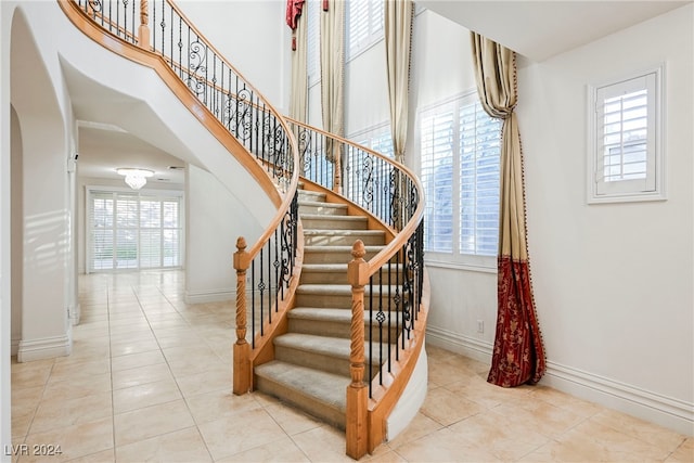 stairs with tile patterned floors and plenty of natural light