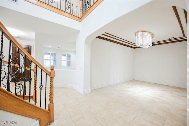 entryway featuring ornamental molding and an inviting chandelier