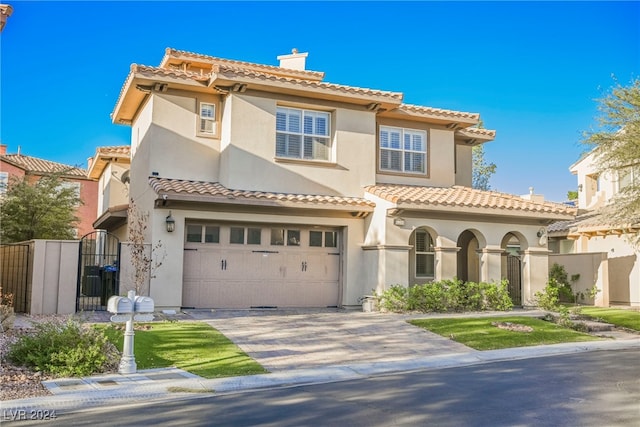 mediterranean / spanish home with a garage