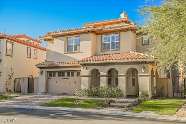 mediterranean / spanish-style house with a garage