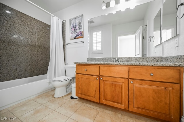 full bathroom with vanity, shower / bath combo with shower curtain, toilet, and tile patterned floors