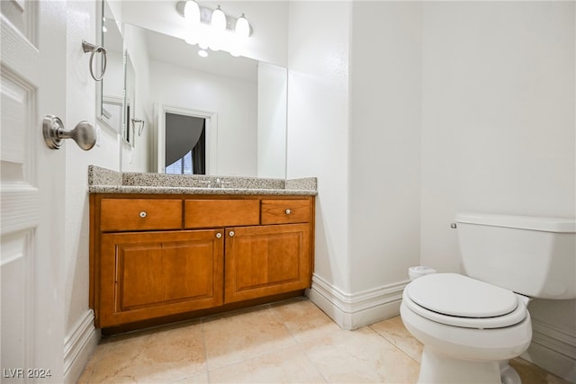 bathroom with vanity, toilet, and tile patterned flooring