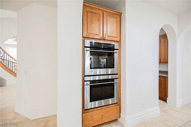 kitchen with light tile patterned floors and double oven