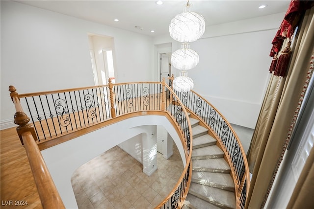 stairway featuring an inviting chandelier