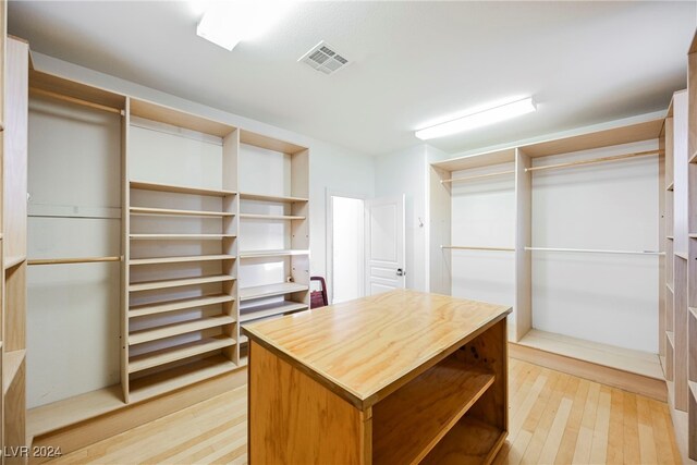 spacious closet featuring light hardwood / wood-style floors