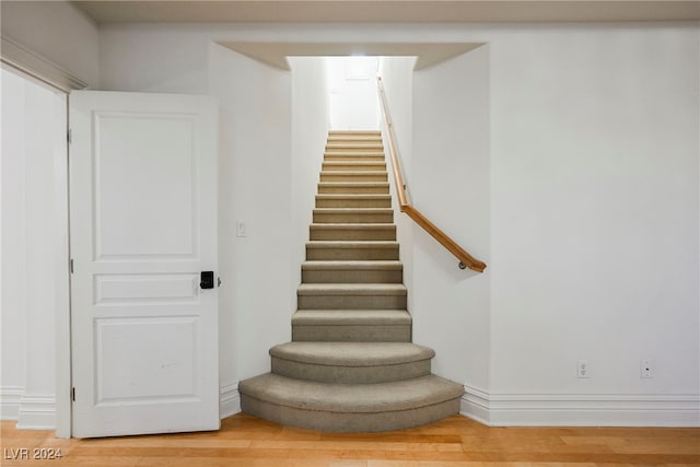 staircase with wood-type flooring