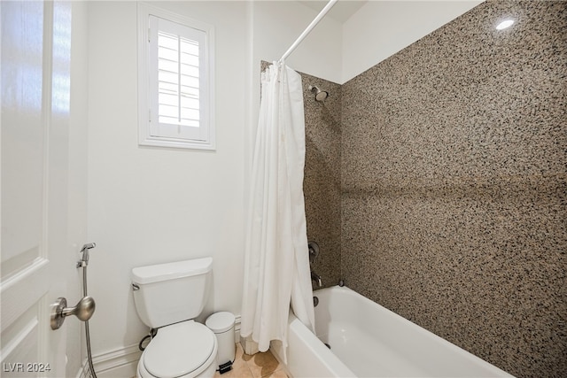 bathroom with tile patterned floors, shower / bath combo, and toilet