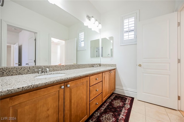 bathroom featuring vanity, a healthy amount of sunlight, and tile patterned floors