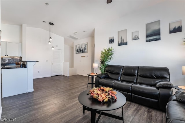 living room with lofted ceiling and dark hardwood / wood-style floors