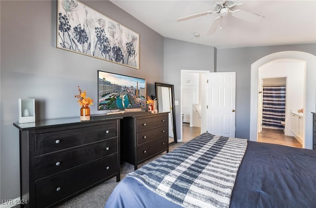 carpeted bedroom featuring ceiling fan and ensuite bathroom