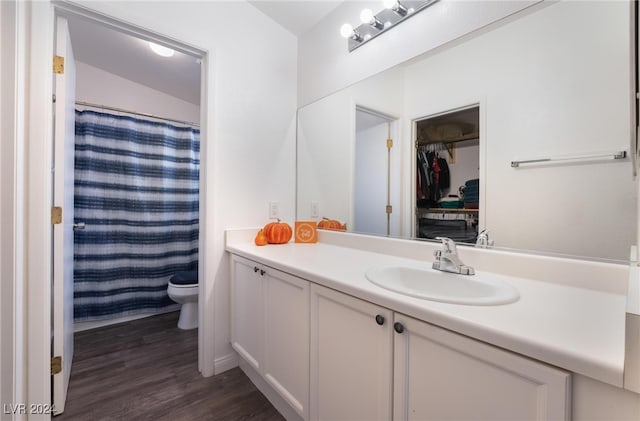 bathroom with toilet, vanity, a shower with shower curtain, and hardwood / wood-style floors