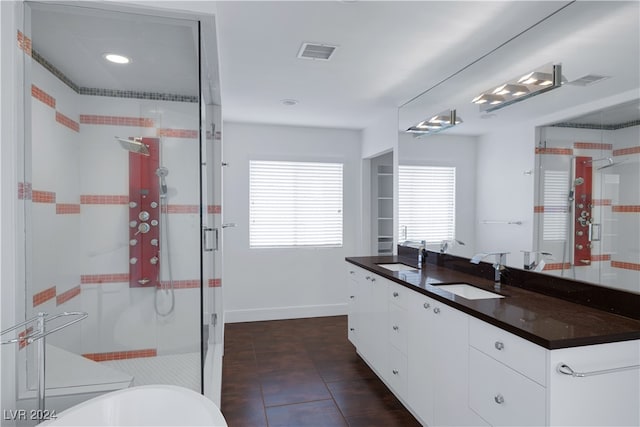 bathroom featuring an enclosed shower, tile patterned floors, and vanity