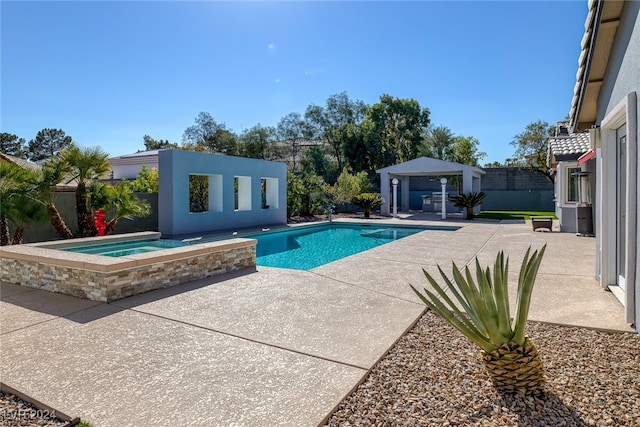 view of pool with an in ground hot tub and a patio area