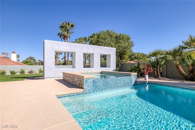 view of pool featuring an in ground hot tub and a patio area