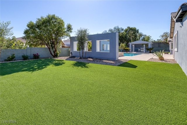 view of yard featuring a fenced in pool and a patio