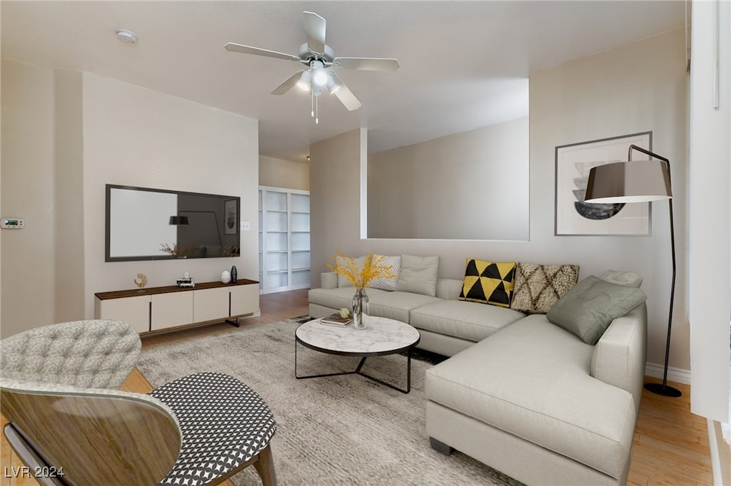 living room featuring ceiling fan and light hardwood / wood-style flooring