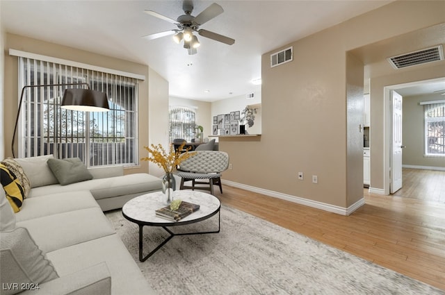 living room featuring ceiling fan and hardwood / wood-style flooring