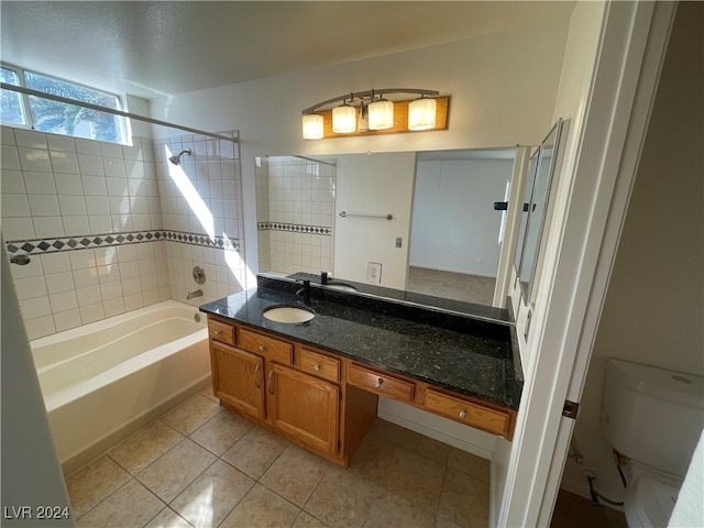 full bathroom with vanity, tile patterned flooring, toilet, and tiled shower / bath combo