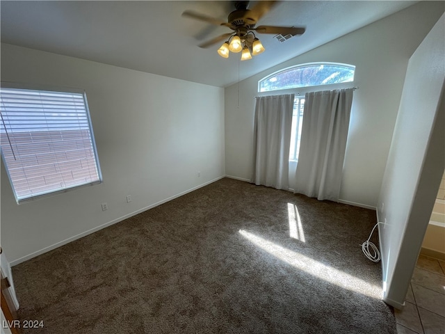 carpeted empty room with ceiling fan and lofted ceiling