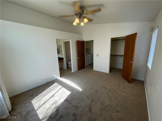 unfurnished bedroom with ceiling fan, separate washer and dryer, light colored carpet, and ensuite bath