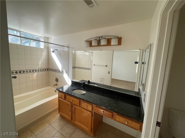 bathroom with tile patterned flooring, vanity, and a textured ceiling