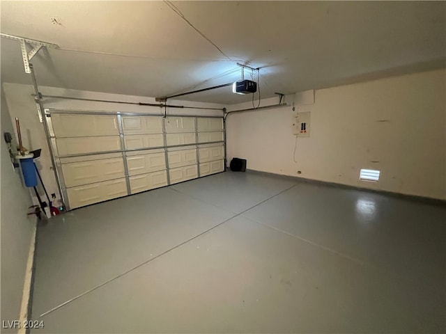 garage featuring a garage door opener and electric panel