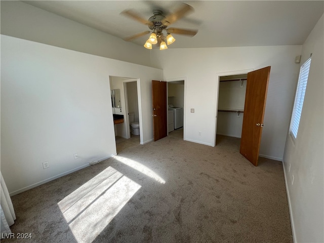 unfurnished bedroom featuring ceiling fan, washing machine and clothes dryer, a closet, light carpet, and ensuite bathroom