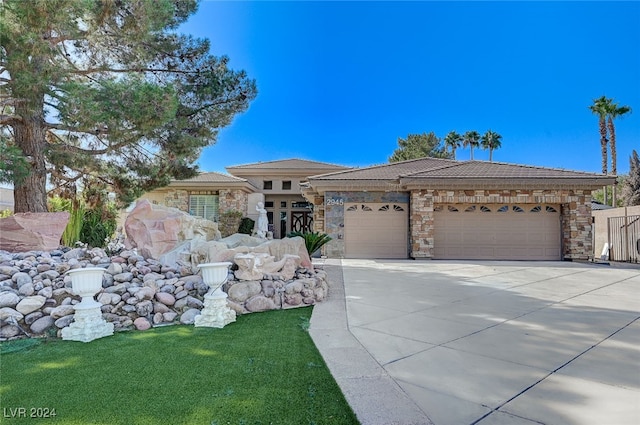 view of front of home featuring a garage and a front yard