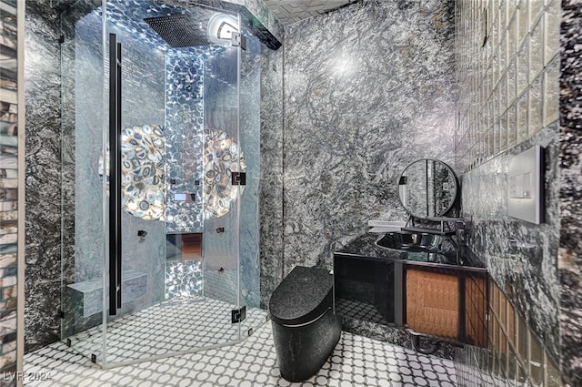 bathroom featuring vanity, an enclosed shower, and tile walls