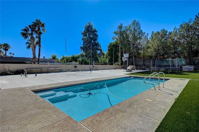 view of pool with a lawn